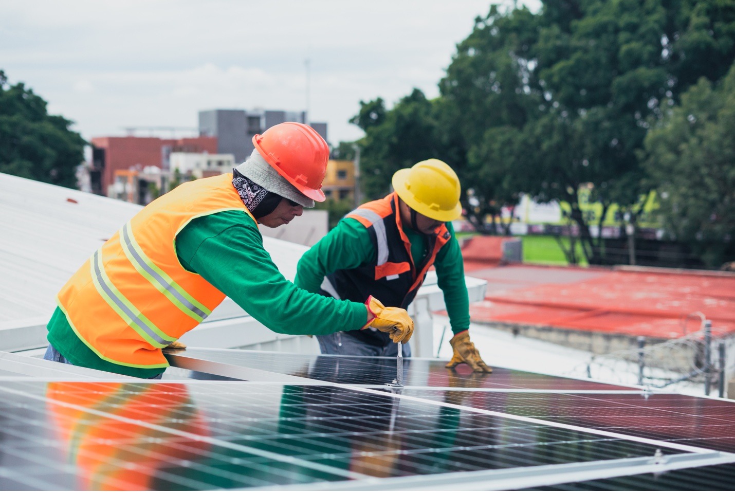 Workers maintaining commercial solar panels.